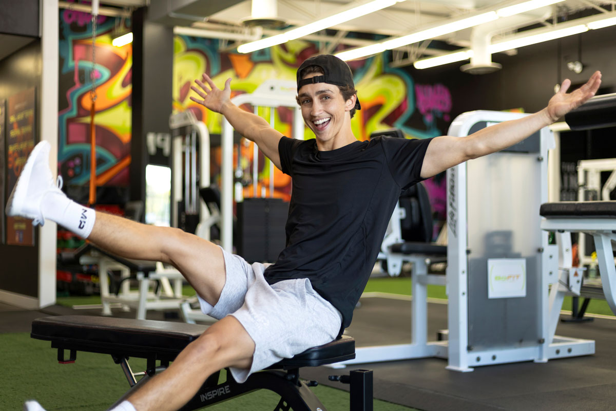 The coach is smiling at the gym.